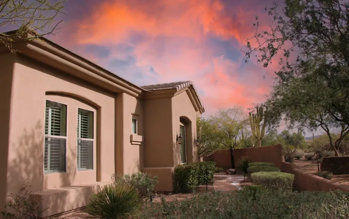 Stucco house with beautiful sky in the background - why does mold grow in my house