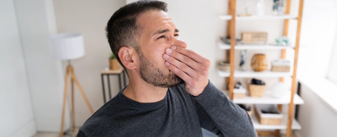 A picture of odor removal in phoenix and a man holding his nose wondering: what does mold smell like.