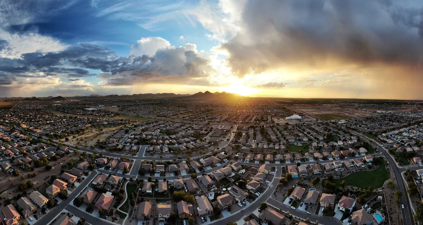 Aerial panorama of a great sunset over a suburb of Surprise, Arizona, where Moldgone offers mold remediation and removal.